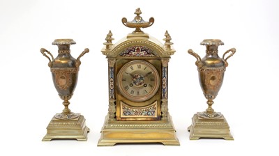 Lot 1034 - AD Mougin: a 19th Century French brass and champleve three-piece clock garniture