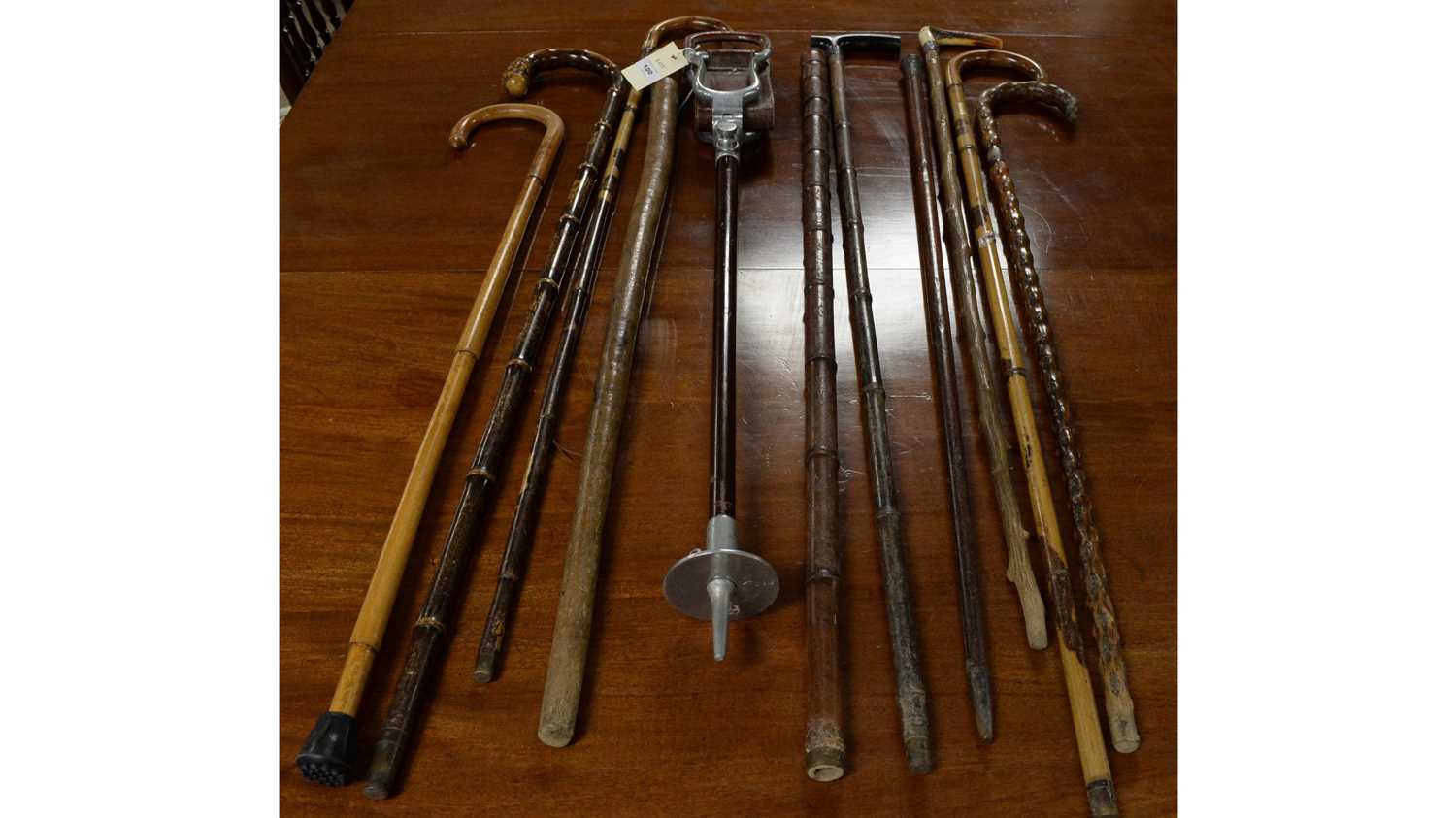 Lot 100 - A selection of vintage walking sticks and canes.