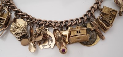 Lot 414 - A gold charm bracelet