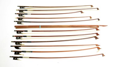 Lot 502 - ten various violin bows, a modern bow and two sticks