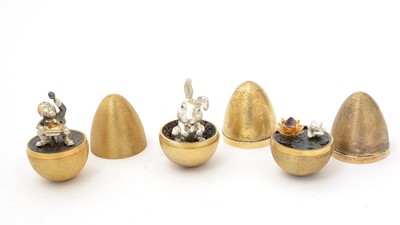 Lot 389 - Three Elizabeth II silver and parcel-gilt surprise eggs.
