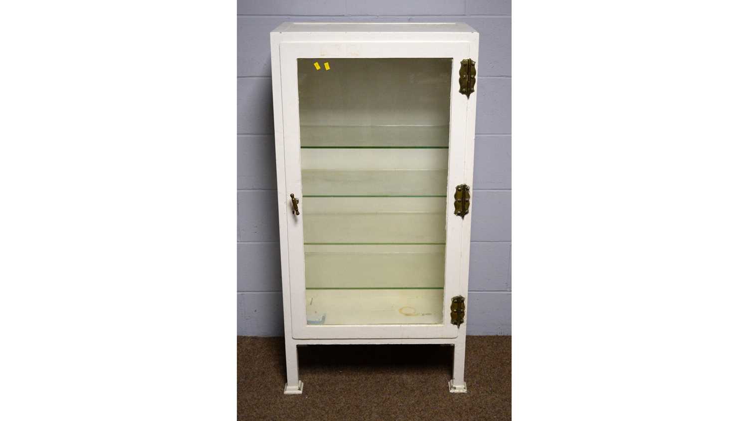 Lot 24 - A vintage white-painted metal surgical instrument display cabinet.