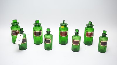 Lot 286 - A collection of green glass apothecary bottles.