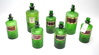 Lot 301 - A collection of green glass apothecary bottles.
