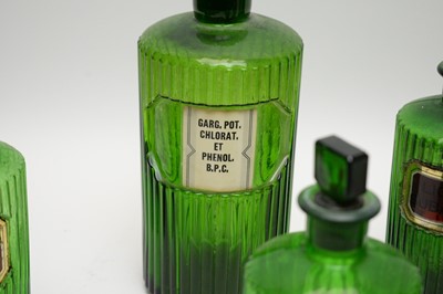 Lot 301 - A collection of green glass apothecary bottles.