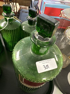 Lot 301 - A collection of green glass apothecary bottles.