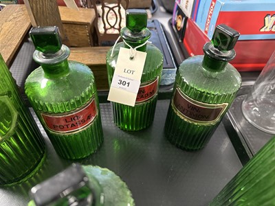 Lot 301 - A collection of green glass apothecary bottles.
