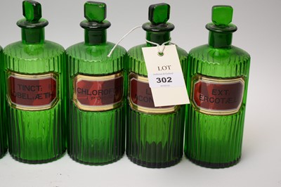 Lot 302 - A collection of green glass apothecary bottles.