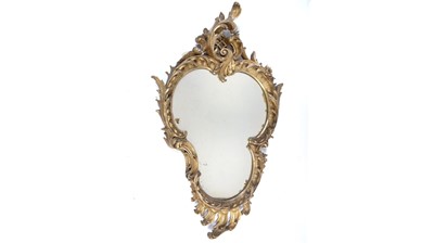 Lot 1081 - A 19th Century giltwood rococo-style wall mirror.