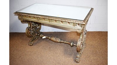 Lot 27 - An ornate silver-painted Italian-style side table.