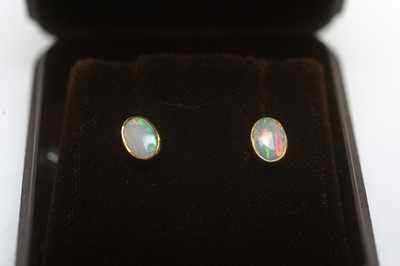 Lot 185 - An opal ring, and a pair of opal earrings.