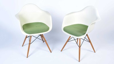 Lot 34 - Vitra after a design by Charles and Ray Eames: a pair of white plastic chairs.