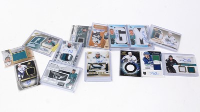 Lot 333 - A selection of Ice hockey trading cards; a puck; and other related items.