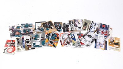 Lot 333 - A selection of Ice hockey trading cards; a puck; and other related items.