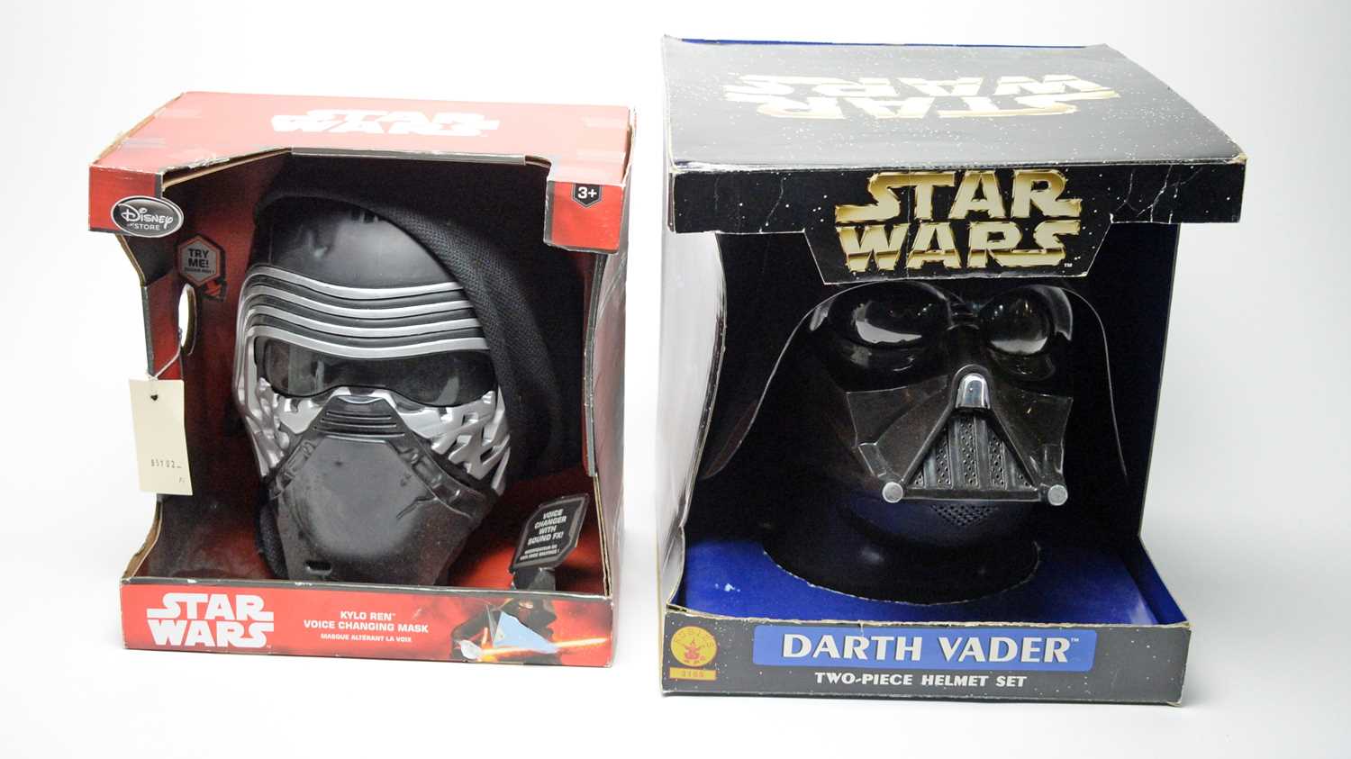 Lot 221 - Star Wars Disney Kylo Ren mask; and a Darth Vader two-piece helmet set.