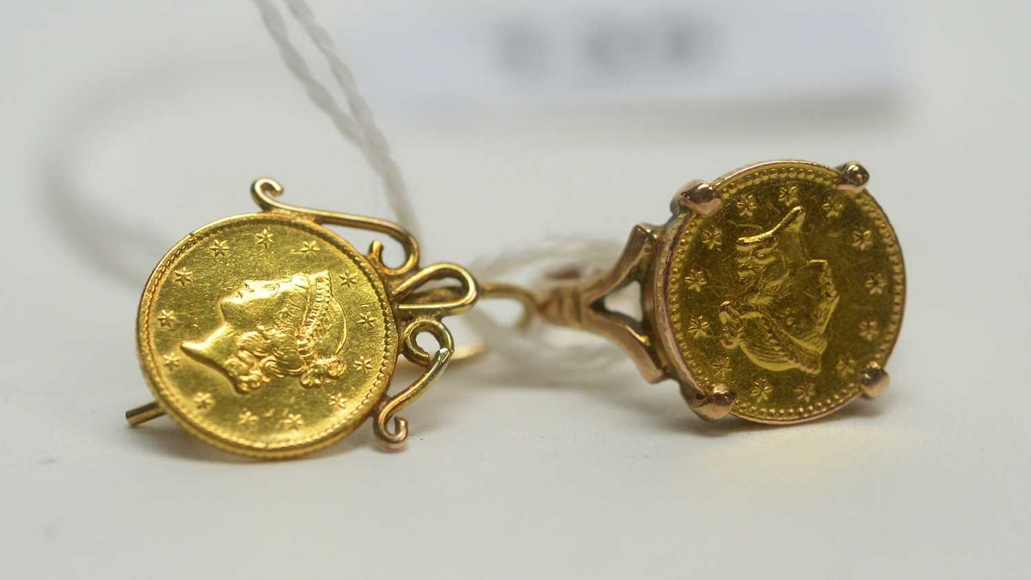 Lot 135 - Two gold dollars in jewellery mount
