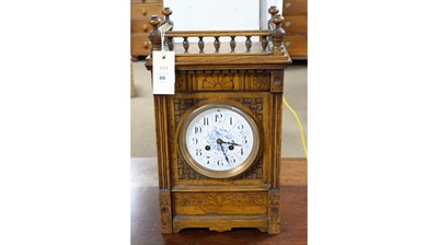Lot 86 - A late 19th Century carved oak mantel clock in the Aesthetic taste.