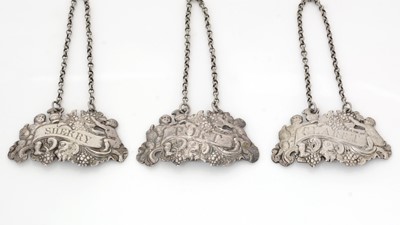 Lot 258 - A set of three early George III silver wine labels.