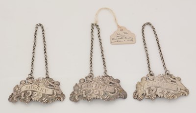 Lot 258 - A set of three early George III silver wine labels.