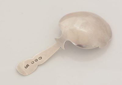 Lot 53 - A George III silver engraved caddy spoon.