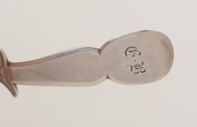 Lot 53 - A George III silver engraved caddy spoon.