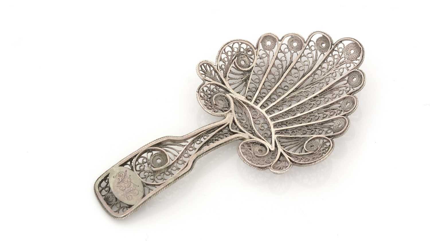 Lot 74 - A George III silver filigree-work caddy spoon.