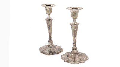 Lot 166 - A pair of George V silver candlesticks.