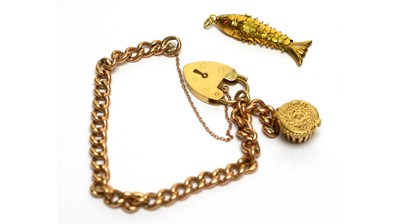 Lot 148 - A 9ct rose gold curb link charm bracelet