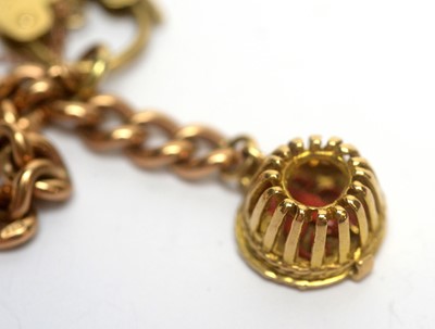 Lot 148 - A 9ct rose gold curb link charm bracelet