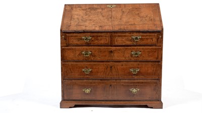 Lot 1136 - An early Georgian burr walnut and feather banded bureau