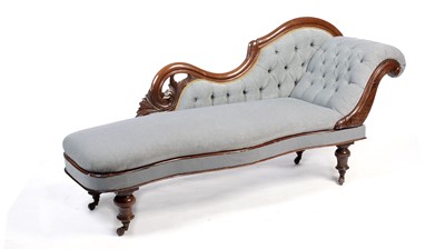 Lot 1138 - A Victorian carved walnut and button-upholstered chaise longue.