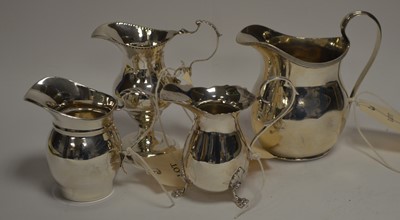 Lot 152 - Four silver cream jugs