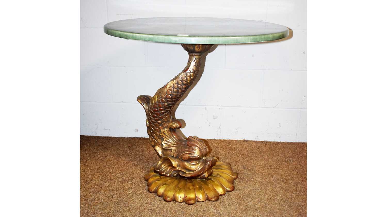 Lot 36 - An ornate dolphin pattern fibreglass centre table.