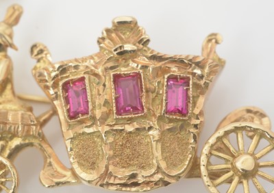 Lot 454 - An 18ct yellow gold and ruby brooch, in the form of a horse-drawn carriage