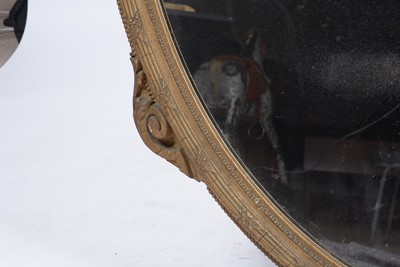 Lot 1082 - A 19th Century oval giltwood and gesso wall mirror.