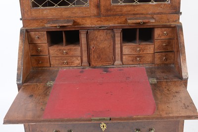 Lot 1115 - A Queen Anne walnut bureau bookcase.