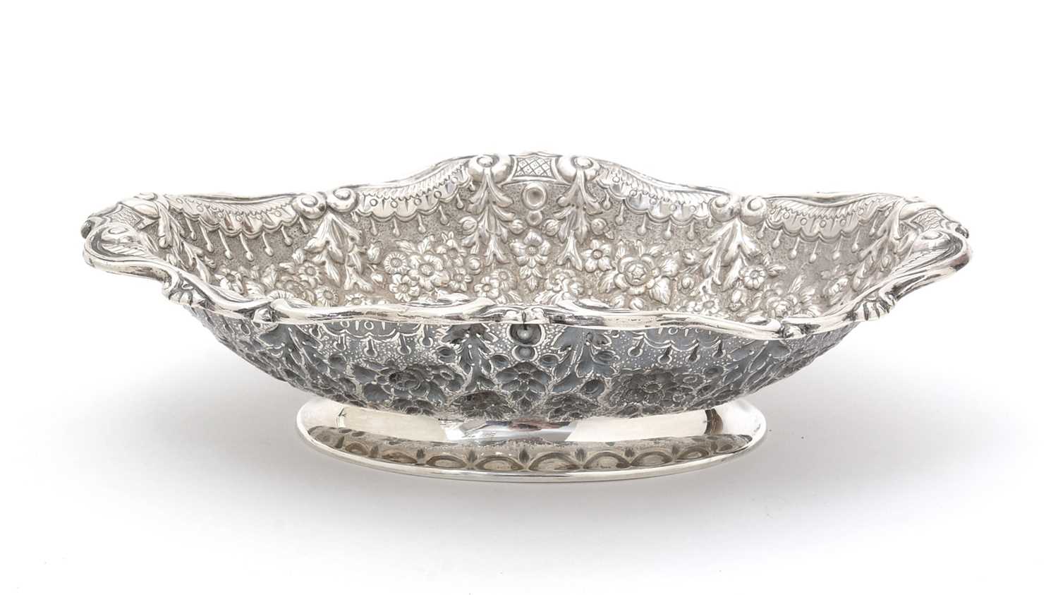 Lot 138 - A late Victorian embossed silver dish.