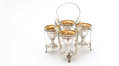 Lot 162 - A George III silver egg frame, four later egg spoons and four plated egg cups.