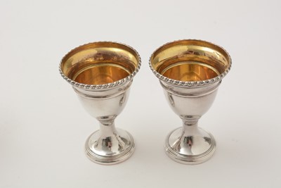 Lot 162 - A George III silver egg frame, four later egg spoons and four plated egg cups.