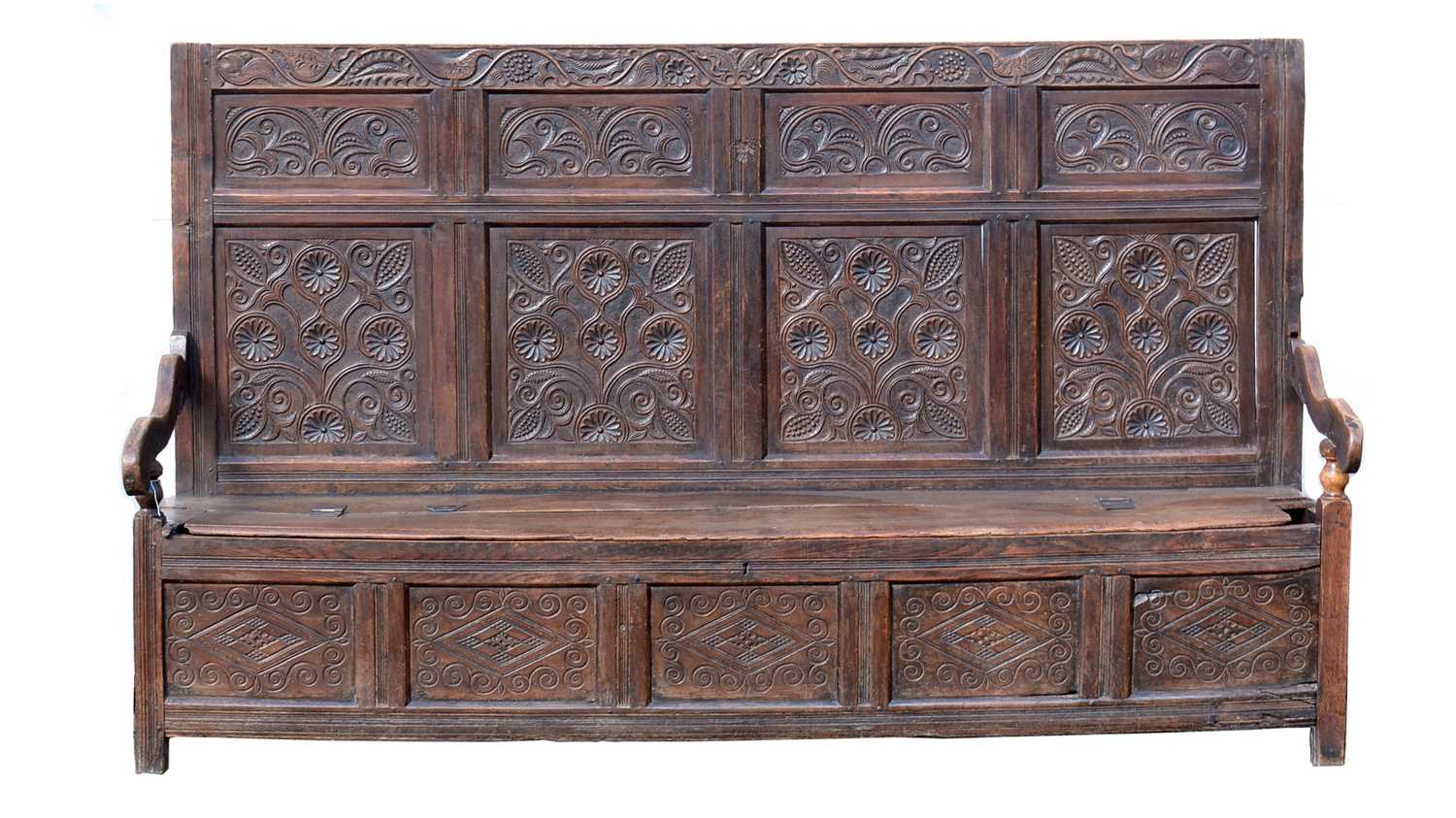 Lot 1104 - A North Country joined and carved oak box settle.