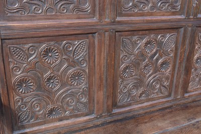 Lot 1104 - A North Country joined and carved oak box settle.
