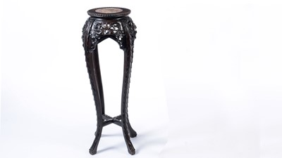 Lot 1077 - A Chinese carved hardwood circular jardiniere stand.