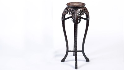 Lot 1078 - A Chinese carved hardwood circular jardiniere stand.