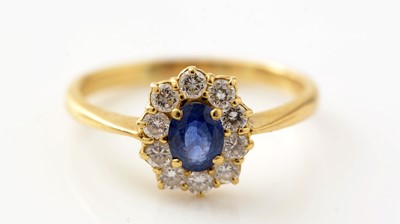 Lot 428 - A sapphire and diamond cluster ring