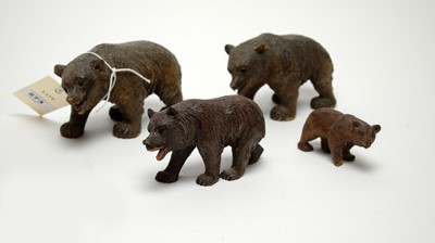 Lot 273 - A set of four early 20th Century carved wooden Black Forest bear family