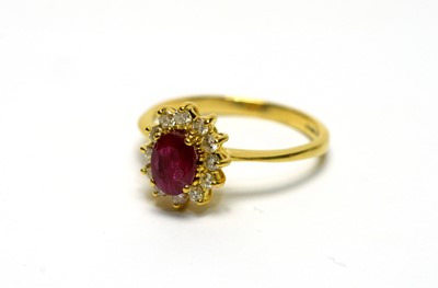 Lot 127 - A ruby and diamond cluster ring