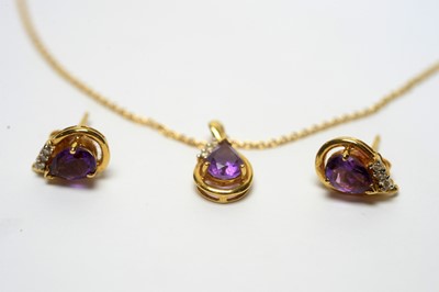 Lot 103 - An amethyst and diamond pendant and matching earrings
