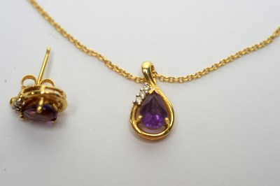Lot 103 - An amethyst and diamond pendant and matching earrings