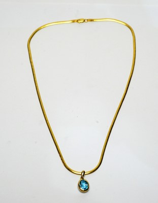 Lot 101 - A topaz pendant on chain.