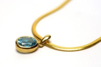 Lot 101 - A topaz pendant on chain.